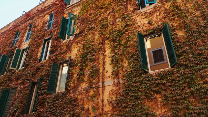 Picturesque buildings in the old town of Rome Italy, featuring red ivy 

