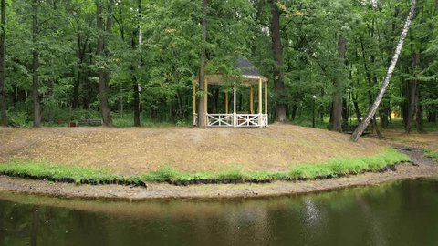 Drone Flying above Pond around Park Gazebo