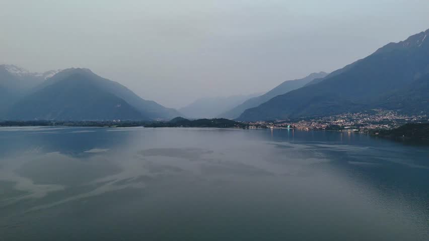 Panoramic view of Lake Como at twilight with Alpine mountain range background