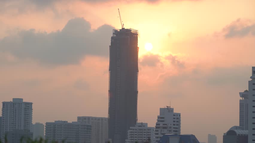 Bangkok skyline during sunset with urban buildings and construction activity