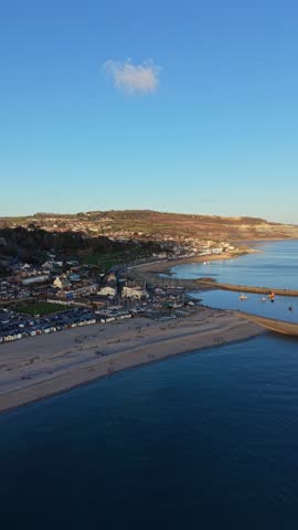 Aerial View of Lyme Regis Town and Harbour at Sunset, Dorset, England