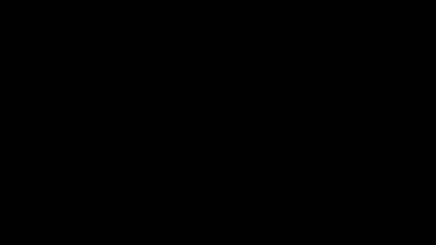 Many shining stars falling while rotating on a black background