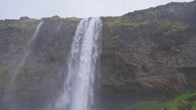 Majestic Seljalandsfoss waterfall during rain storm in Iceland - Powered by Shutterstock - Get 15% off with code: PIKWIZARD15