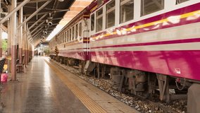 Tracking shot along vintage pink passenger train at quiet covered Bangkok railway platform - Powered by Shutterstock - Get 15% off with code: PIKWIZARD15