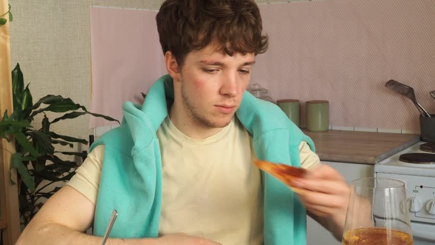 Attractive guy eats homemade pizza for lunch