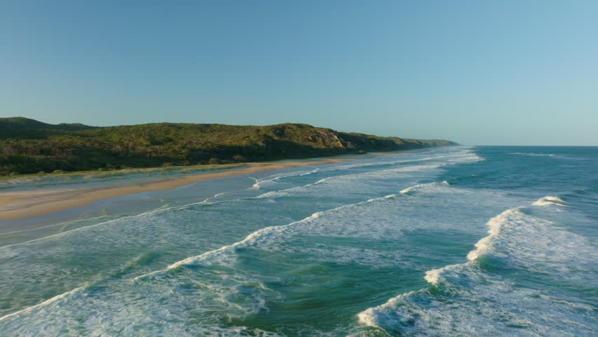 Aerial Rolling Ocean Blue Waves Towards Sand Beach Shore Of Kgari Fraser Island, Australia, 4K Drone