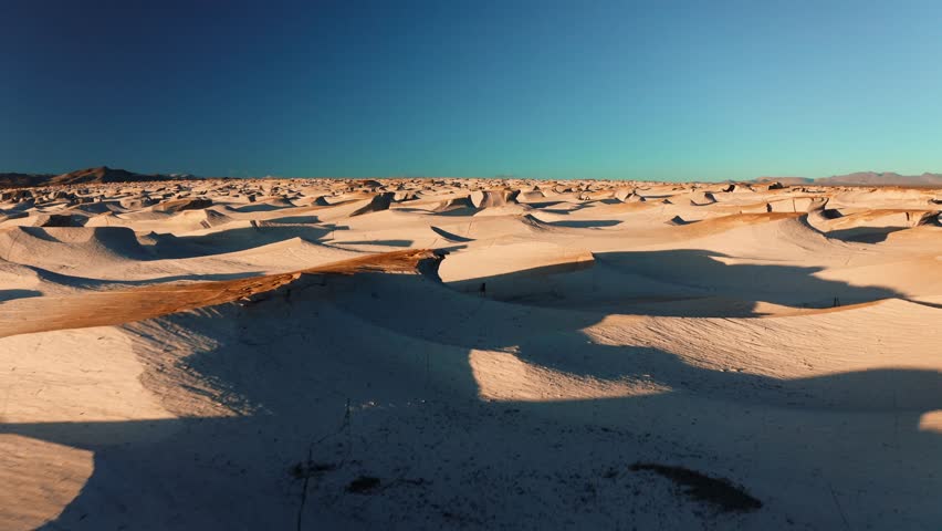 Sweeping of sculpted pumice hills and shadows across expansive Campo de Piedra Pomez desert