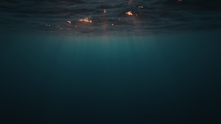 Underwater view of the sea surface with gentle waves during sunset