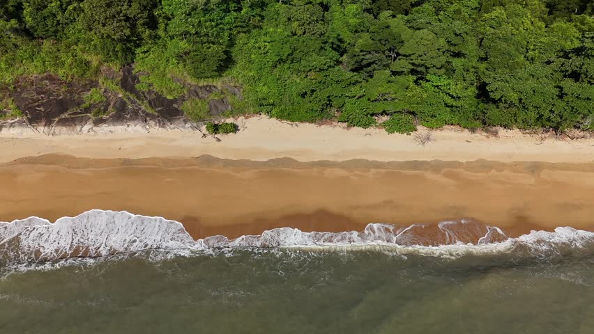 Phu Quoc Island, An Giang, Vietnam – 4K Aerial Drone View of Tropical Beaches, Turquoise Water, Sandy Shoreline, Rocky Coast, Coral Reefs and Lush Coastal Forest. Phu Quoc Island, An Giang Province, Vietnam viewed from an elevated aerial perspective, showcasing clear turquoise waters meeting sandy beaches, rocky shorelines, and shallow reef areas along the tropical coast. The scene highlights gentle waves, underwater textures, and vibrant colour gradients created by sunlight over calm coastal waters.
Natural contrasts between white sand, emerald-green sea, dark rock formations, and dense coastal vegetation emphasise the island’s unspoilt character. The expansive viewpoint captures the tranquil atmosphere of Vietnam’s largest island, blending tropical marine environments with untouched shoreline landscapes.
Ideal for projects focused on tropical destinations, island landscapes, beach and ocean scenery, travel and tourism, nature and environment, coastal ecosystems, relaxation themes, and cinematic natural backgrounds.