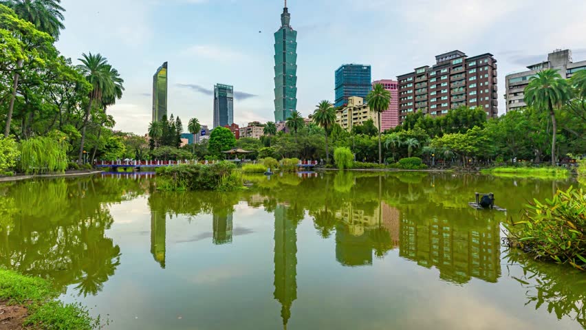 
Beautiful Time lapse Taipei City Sunrise view cityscape of Taiwan at dawn with reflection of the city skyline with the Taipei 101 by a lake in a city park.