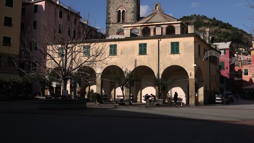 Central square with bell tower and clock in Monterosso, Italy. Historic center of town in Cinque Terre. Tourism and recreation.