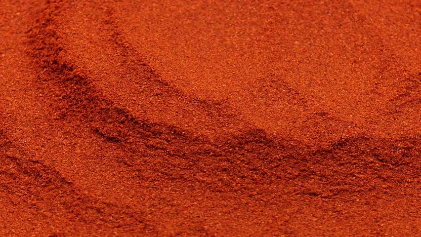 Ground red chili powder waves texture background for spicy food