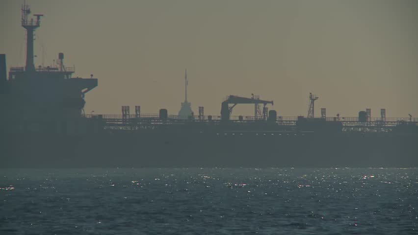 Silhouetted Cargo Ship Reveals the Maiden Tower Behind in Istanbul