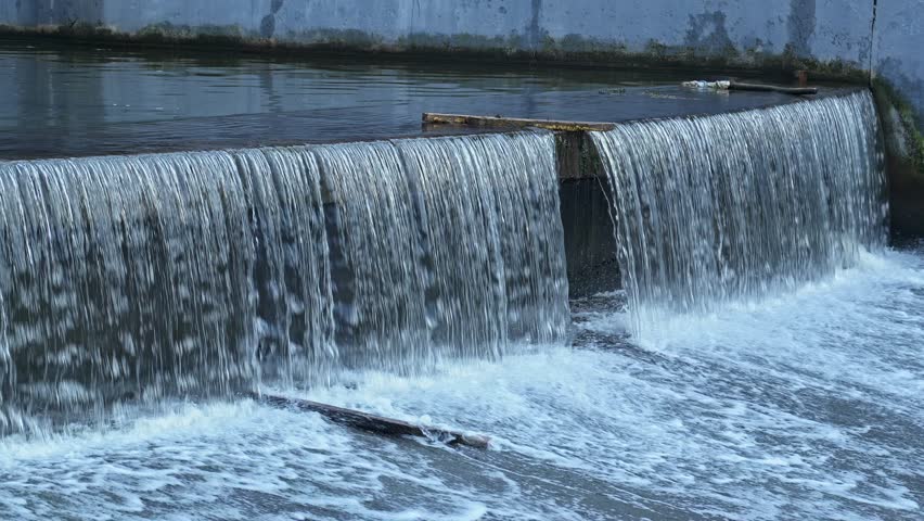 Calming flow of water cascading over beautiful waterfall in serene location during gentle light of dusk. Peaceful atmosphere inviting relaxation and reflection. 4K, UHD