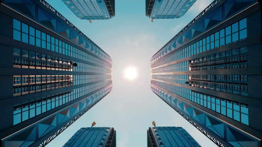 A camera moves upward from ground level between tall skyscrapers toward the sun above, with reflective glass mirroring neighboring buildings and the sky.