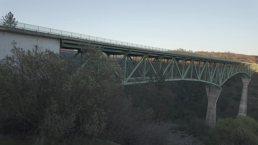 Wide panning shot capturing the full scale of the Foresthill Bridge in Auburn, California.