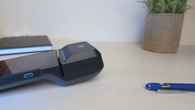 Slow motion mobile contactless payment using smartphone on POS terminal placed on desk - Powered by Shutterstock - Get 15% off with code: PIKWIZARD15