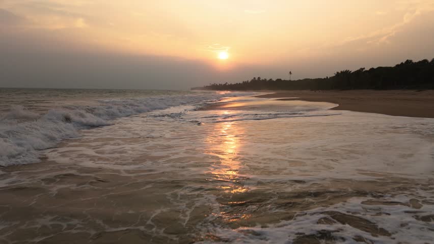 Fly low over Quiet beach in Sri Lanka during golden sunset 2of2