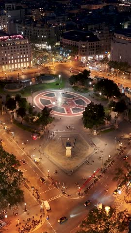 Night Catalunya Square In Barcelona Spain. Aerial View Of A Bustling City With High-Rise Buildings And Traffic. Building Metropolitan Landscape High Rise Building Busy. Metropolitan Enterprise.