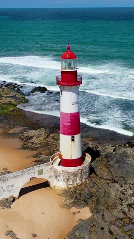 Itapua Lighthouse In Salvador Bahia Brazil. Iconic Structure Of The Historic Lighthouse In A Coastal City. Shore Clouds Beach Sea. Remote Location Beach Panoramic. Salvador Bahia.