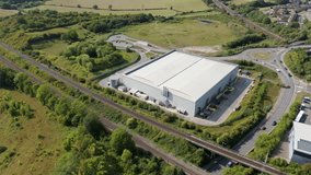 Title	
Aerial view drone flight above business park warehouse district factory units data centre quantum computing on a sunny day in the UK logistics and transport of goods economics. - Powered by Shutterstock - Get 15% off with code: PIKWIZARD15