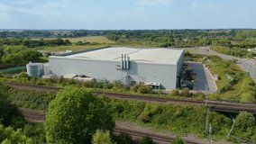 Title	
Aerial view drone flight above business park warehouse district factory units data centre quantum computing on a sunny day in the UK logistics and transport of goods economics. - Powered by Shutterstock - Get 15% off with code: PIKWIZARD15