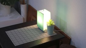 Smart nightlight with a plastic lampshade on a coffee table. Decorative interior lighting with a changing glow.

 - Powered by Shutterstock - Get 15% off with code: PIKWIZARD15