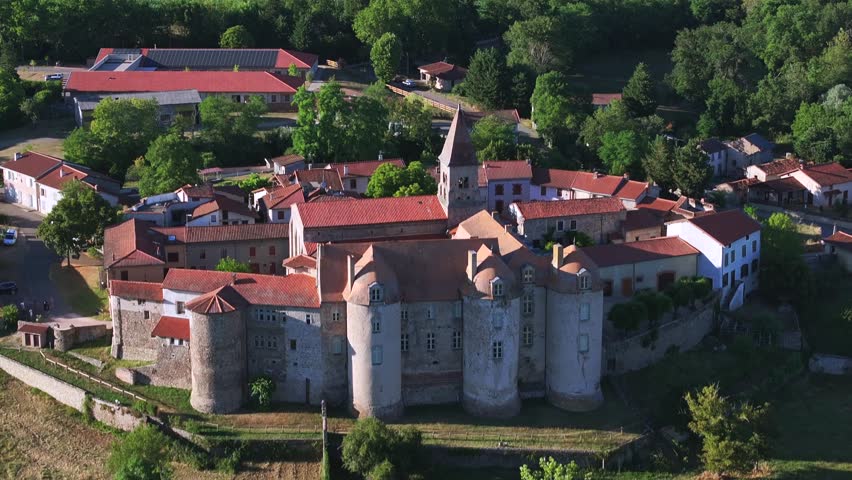 Aerial drone view of an old monastery located in the French countryside. Drone footage of religious architecture and surrounding countryside, filmed in daylight. 4K video.