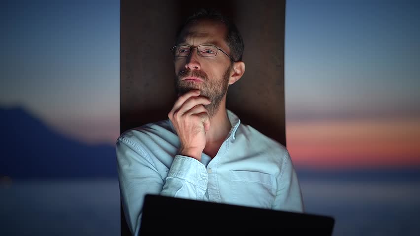 Work and travel concept of young man working on laptop computer outside thinking and brainstorming business ideas