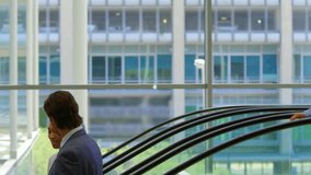 Animation of connected icons, multiracial coworkers sharing ideas while getting down from escalator. Digital composite, multiple exposure, communication, teamwork, discussion and business concept. - Powered by Shutterstock - Get 15% off with code: PIKWIZARD15