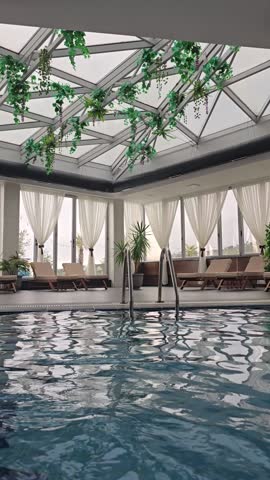 Empty indoors swimming pool with blu water during wintertime