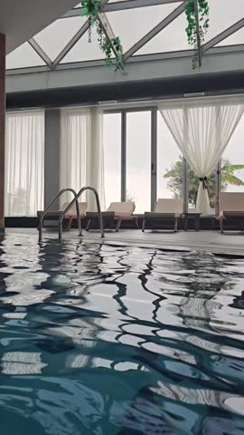 Empty indoors swimming pool with blu water during wintertime