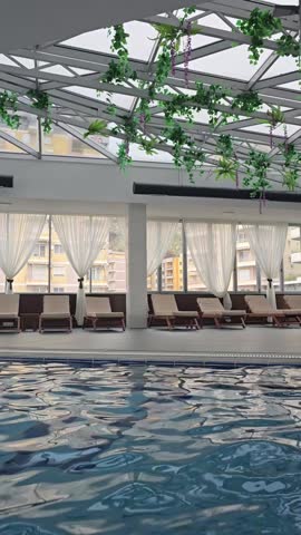 Empty indoors swimming pool with blu water during wintertime