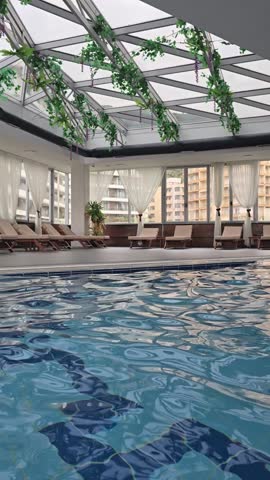 Empty indoors swimming pool with blu water during wintertime