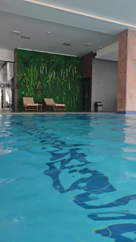 Empty indoors swimming pool with blu water during wintertime