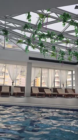 Empty indoors swimming pool with blu water during wintertime