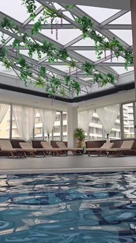 Empty indoors swimming pool with blu water during wintertime