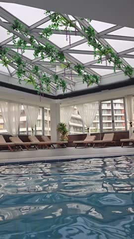 Empty indoors swimming pool with blu water during wintertime