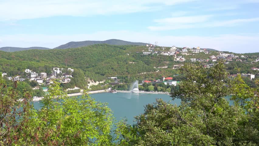 The promenade along Lake Abrau-Dyurso with calm water, greenery, and scenic surroundings.
