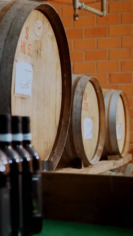 Wooden barrels. winery. wine , cognac, whiskey or brandy warehouse. wooden barrels with wine stacked in rows at wine warehouse, cellar or storage. traditional small family winery.