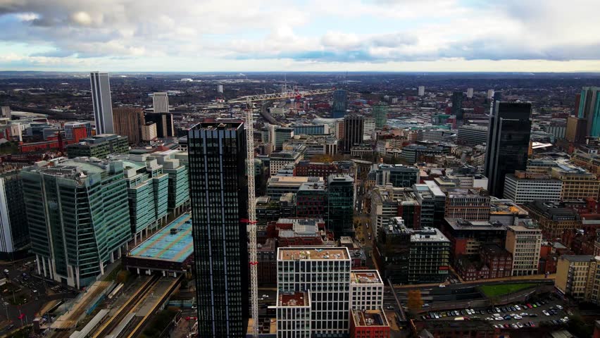 Construction crane over Birmingham city center skyline at daytime