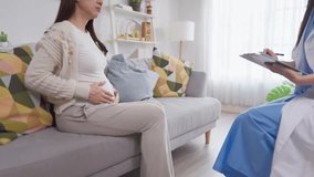 Asian pregnant woman consults with doctor at maternal health center. Attractive expectant mother receive supportive and guidance during a challenging moment in her pregnancy at prenatal care clinic. - Powered by Shutterstock - Get 15% off with code: PIKWIZARD15