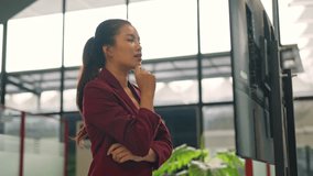 Professional woman interacting with a digital touchscreen kiosk in a modern office or public space - Powered by Shutterstock - Get 15% off with code: PIKWIZARD15