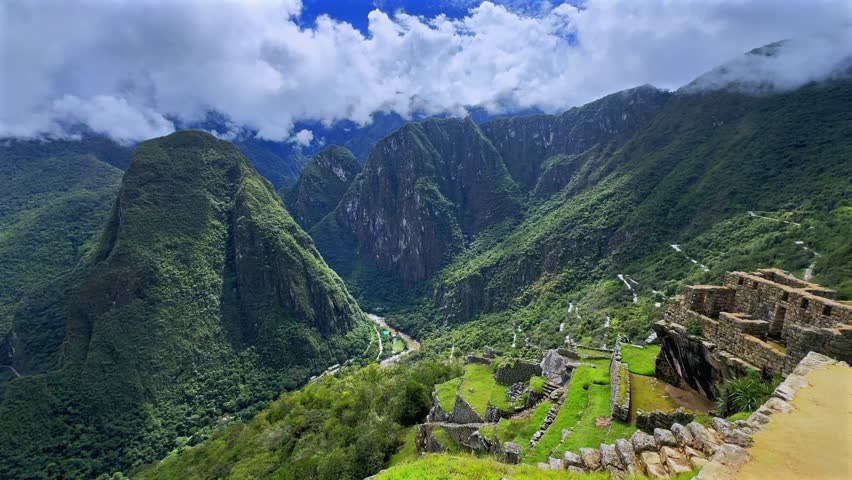 Machu Pichhu Inca Citadel circuit trail terrace Urubamba River Valley Aguas Clients Peru aerial drone Peruvian Andes mountain range jungle sunny morning clouds rainy season landscape Inca Citadel pan
