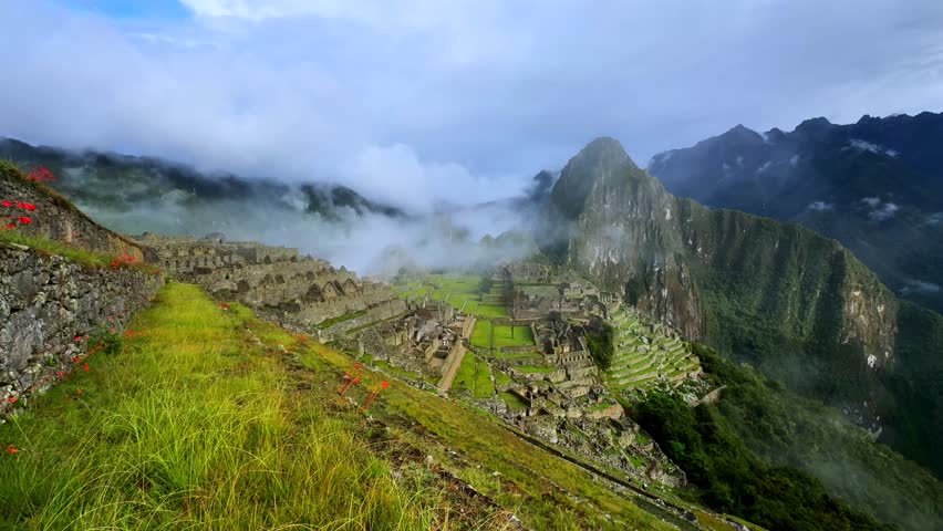 Machu Picchu Historic Sanctuary Temple rainy season Inca citadel Eastern Cordillera of southern Peru Incan citadel high in the Andes Mountains early morning sunrise blue sky low cloud fog circuit two