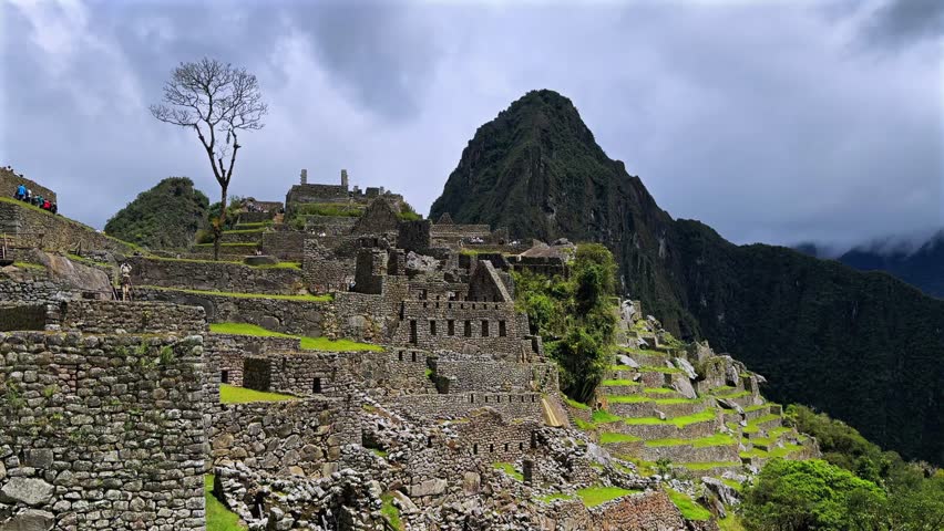 Huayna Picchu Machu Picchu Historic Sanctuary Temple rainy season Inca citadel Eastern Cordillera of southern Peru Incan citadel Peruvian Andes Mountains daytime blue sky low cloud fog landscape