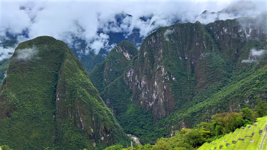 Peruvian Andes mountain range Machu Pichhu Inca Citadel circuit trail terrace Urubamba River Valley Aguas Clients Peru aerial drone jungle sunny morning clouds rainy season landscape Inca Citadel