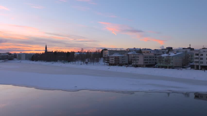 4K cinematic drone footage of Rovaniemi, Finland, captured at golden hour during the winter solstice_48