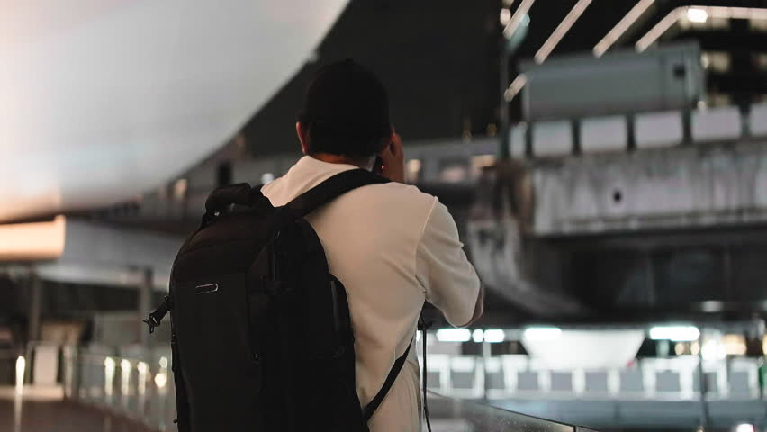 Travel photographer taking pictures in urban environment at night