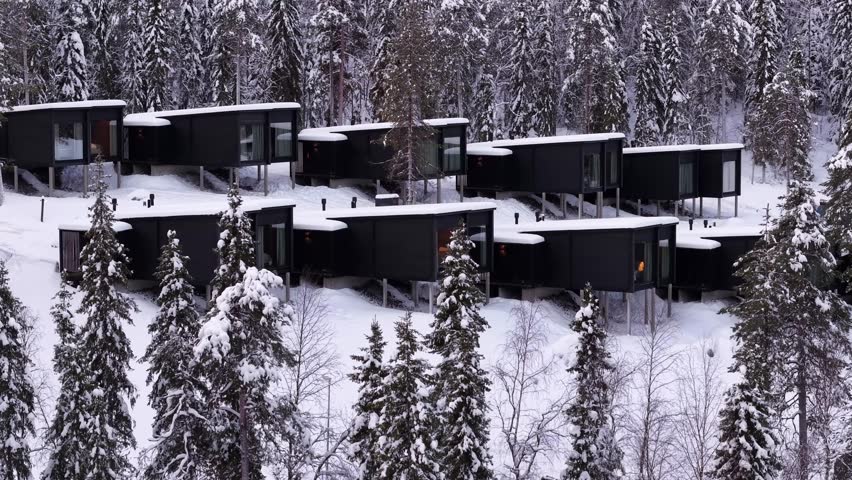 Luxury hotel surrounding boreal forest landscape covered in snow, Romantic chalets, Lapland